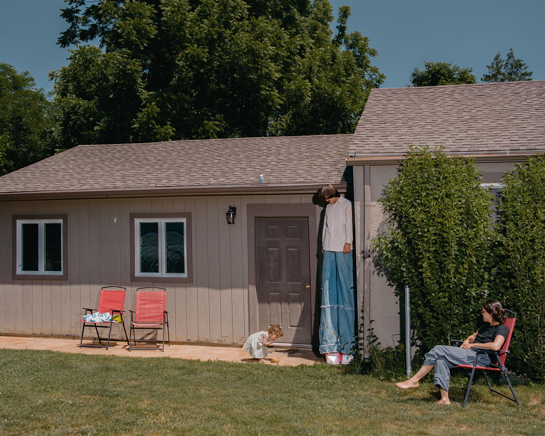 A house and backyard with people outside
