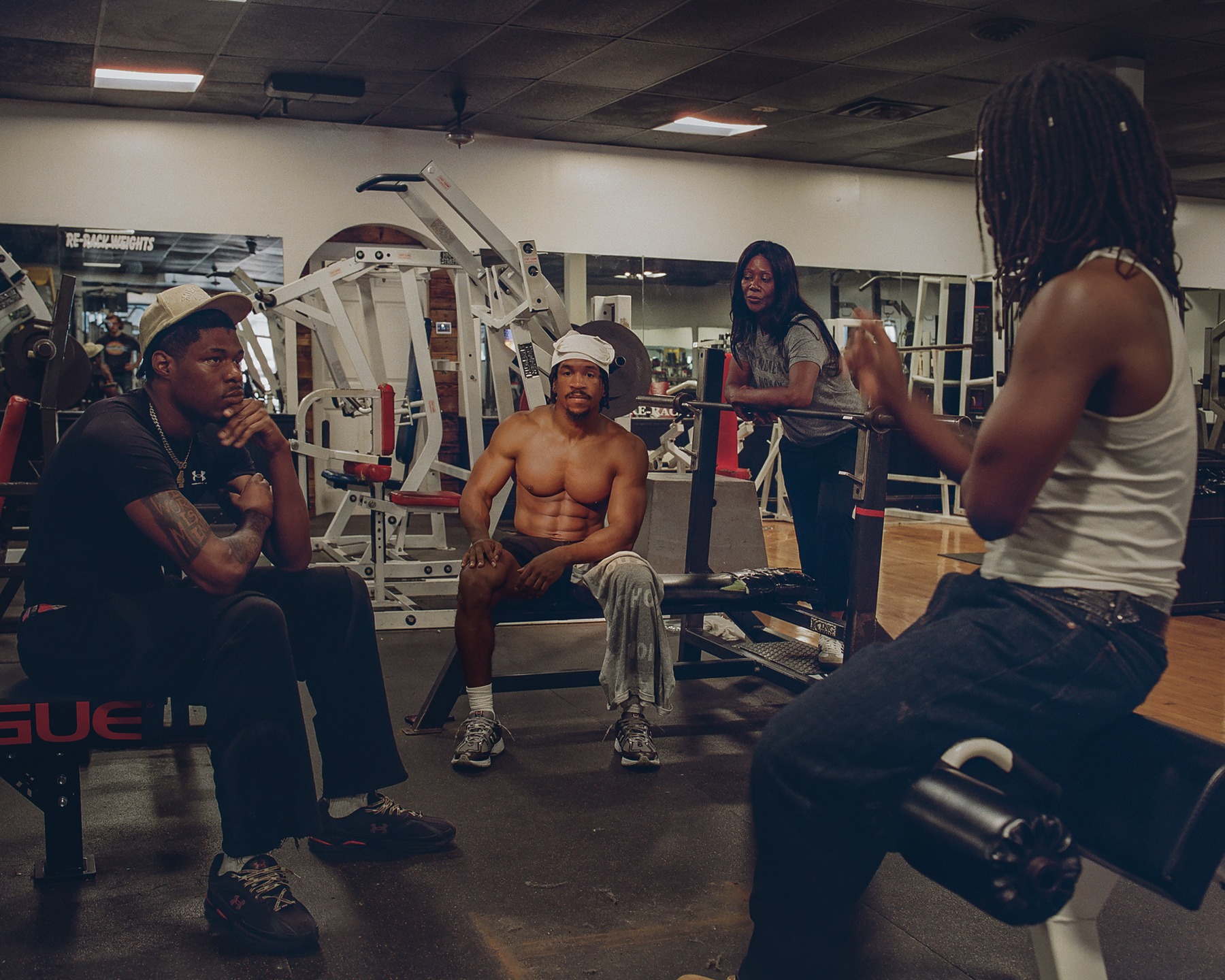 People gathered among equipment in a gym