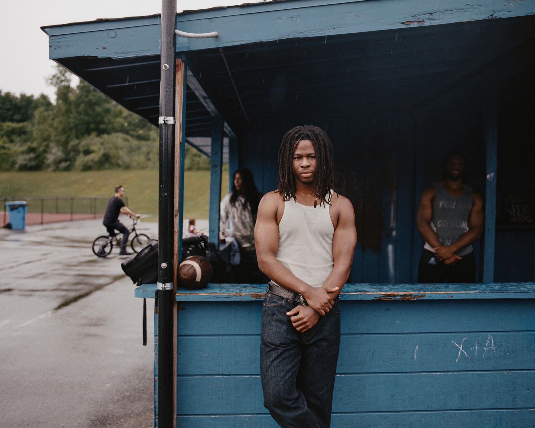A person standing outside a blue roadside building